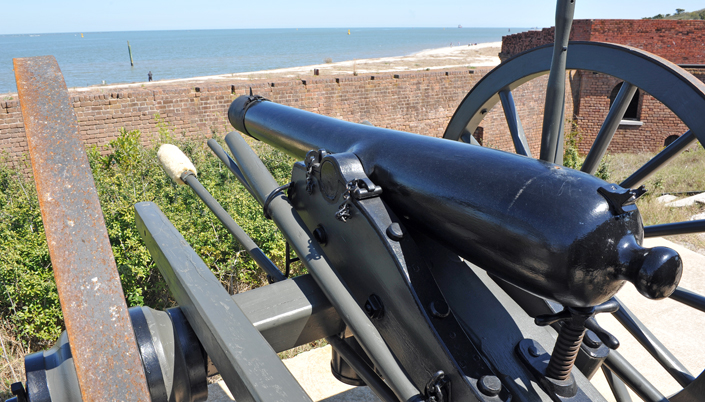 Cannon Aimed at Guy Fishing on Beach