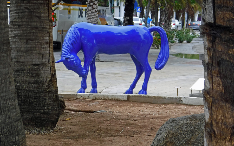 Blue horses are scatted about downtown